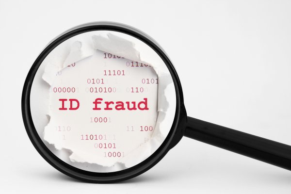 id theft protection service zander magnifying glass over ID fraud on piece of paper 